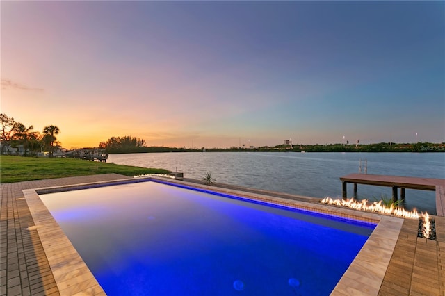 pool at dusk with a water view