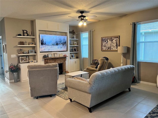 tiled living room with ceiling fan and a textured ceiling