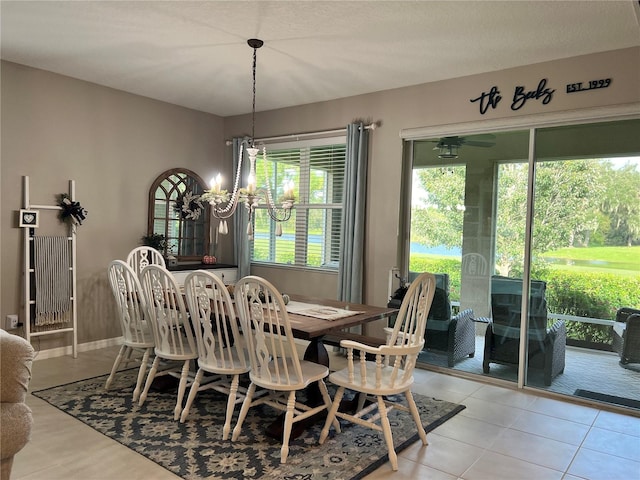 dining area with light tile patterned floors and a chandelier