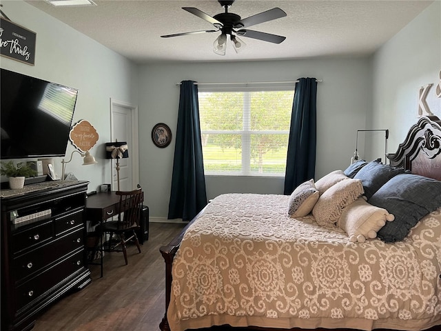 bedroom featuring a textured ceiling, dark hardwood / wood-style floors, and ceiling fan