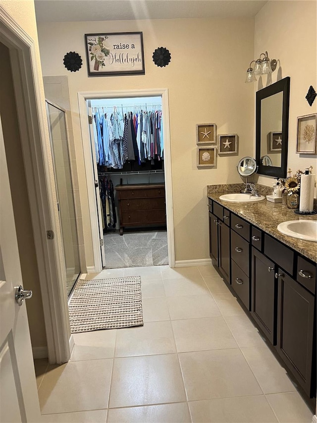 bathroom with tile patterned floors, vanity, and a shower with shower door