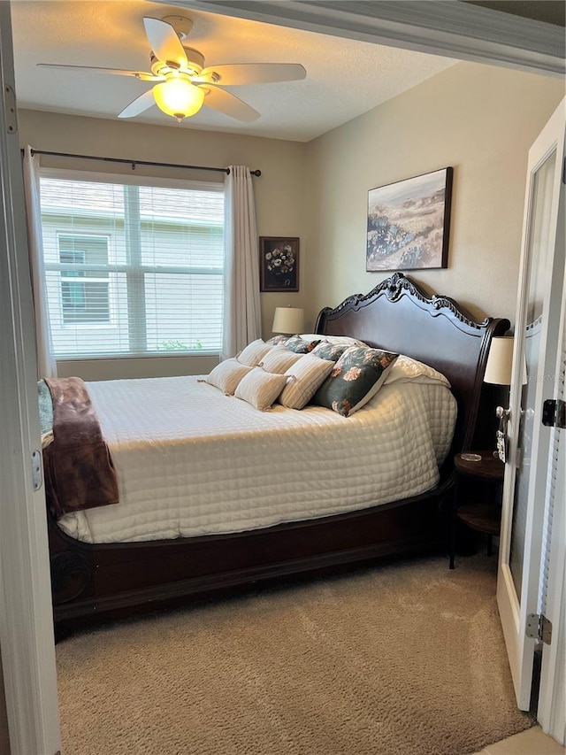 bedroom with ceiling fan and carpet floors