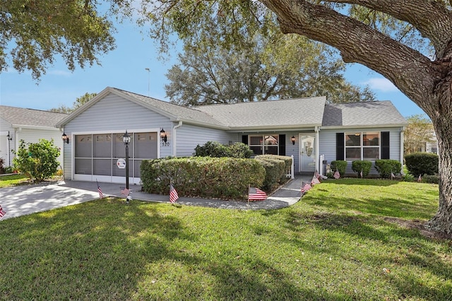 ranch-style home featuring a front lawn and a garage