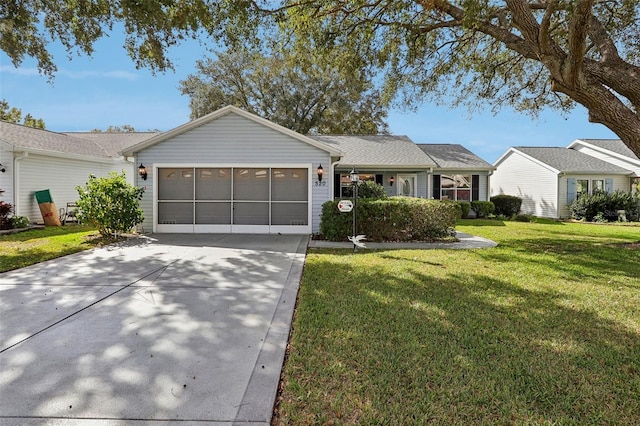 ranch-style home featuring a front lawn and a garage