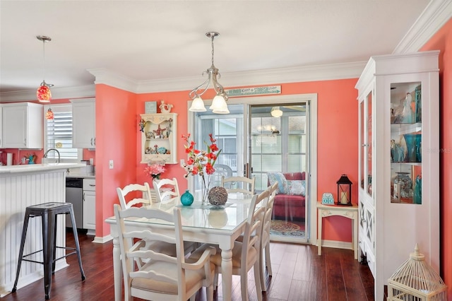 dining room with sink, crown molding, and dark wood-type flooring