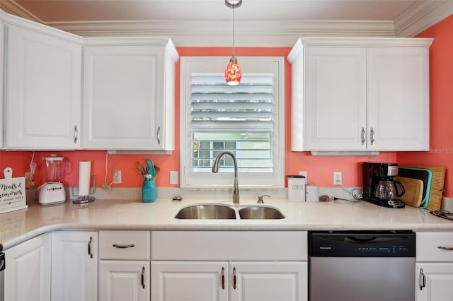 kitchen featuring stainless steel dishwasher, crown molding, sink, white cabinets, and hanging light fixtures