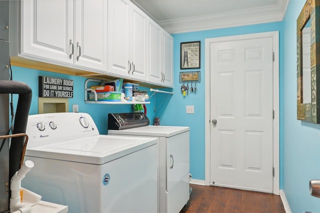 washroom featuring cabinets, dark hardwood / wood-style flooring, washing machine and dryer, and crown molding