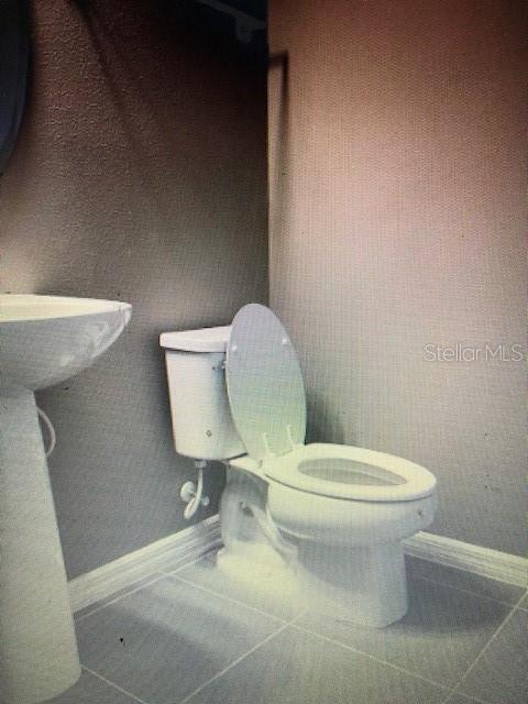 bathroom featuring tile patterned floors and toilet