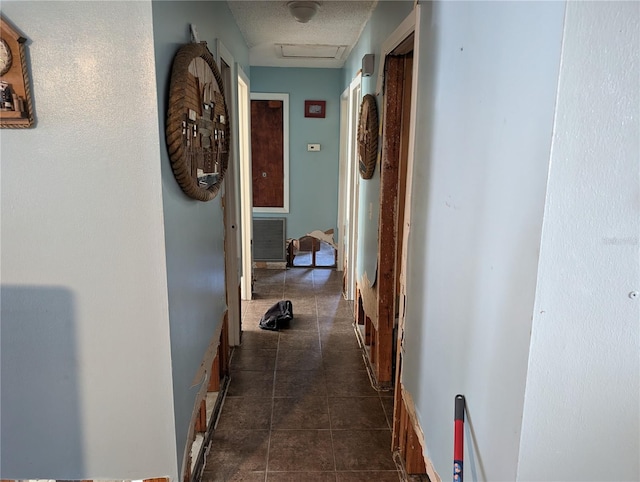 hallway featuring dark tile patterned floors