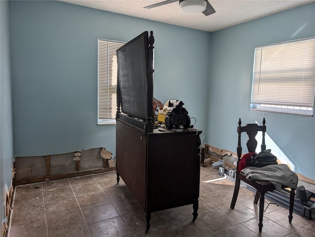 office with a textured ceiling and ceiling fan