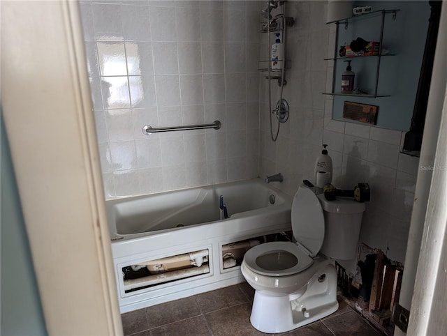 bathroom featuring tile patterned flooring, tiled shower / bath combo, tile walls, and toilet