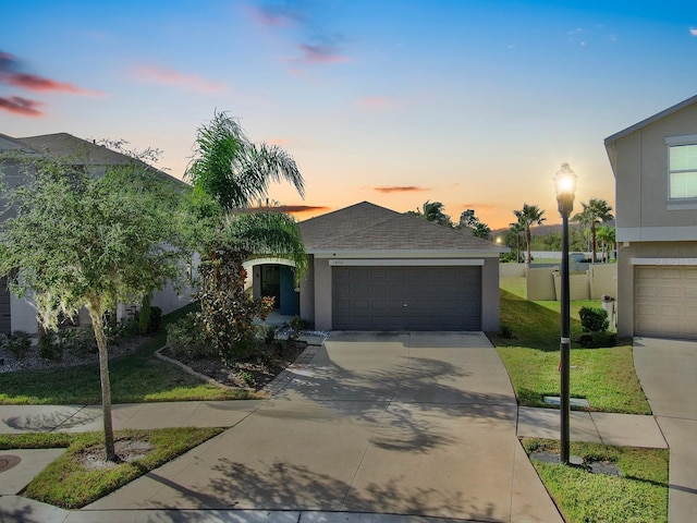 view of front of property featuring a yard and a garage