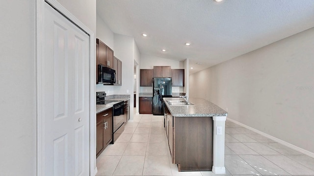 kitchen featuring black appliances, light tile patterned floors, dark brown cabinets, and a sink