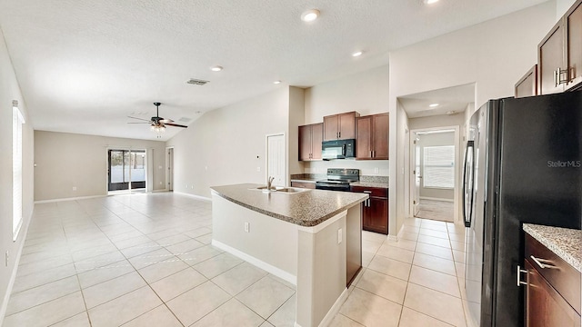 kitchen with light tile patterned floors, visible vents, lofted ceiling, appliances with stainless steel finishes, and a sink