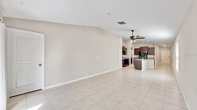 unfurnished living room featuring lofted ceiling, visible vents, a ceiling fan, and light tile patterned flooring