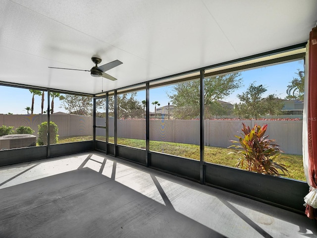 unfurnished sunroom featuring a healthy amount of sunlight and a ceiling fan