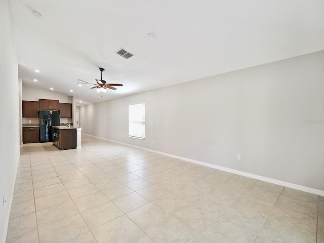 unfurnished living room with lofted ceiling, recessed lighting, visible vents, a ceiling fan, and baseboards