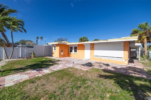 back of property featuring a yard and a patio