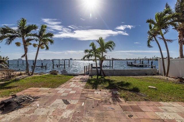 view of patio featuring a water view and a boat dock