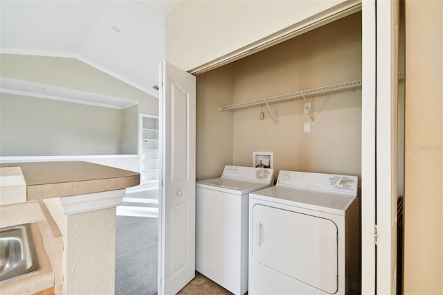 clothes washing area with separate washer and dryer and carpet floors