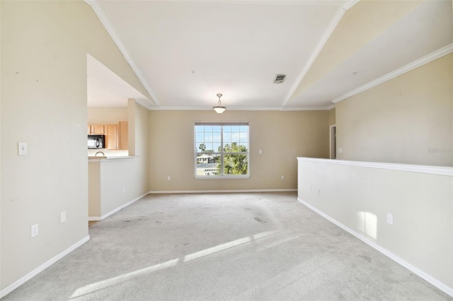 unfurnished room with light colored carpet, ornamental molding, and vaulted ceiling