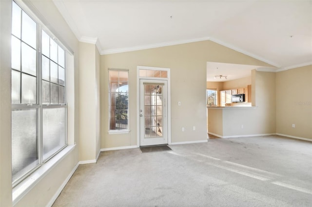 unfurnished room with lofted ceiling, carpet floors, and crown molding