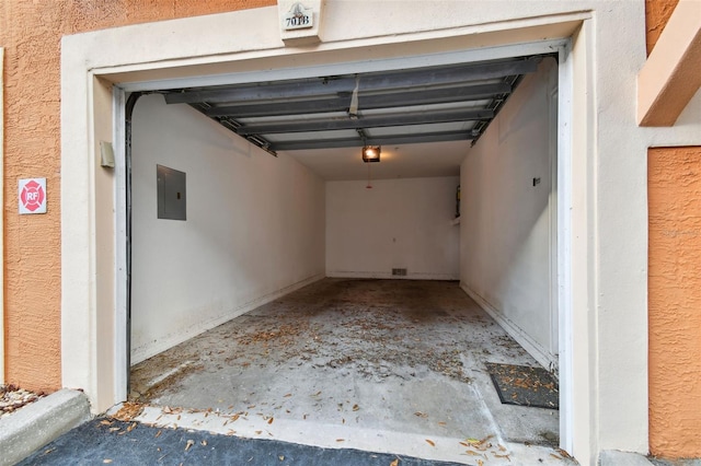 garage featuring electric panel and a garage door opener