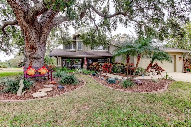 view of front of home with a porch, a front yard, and a garage