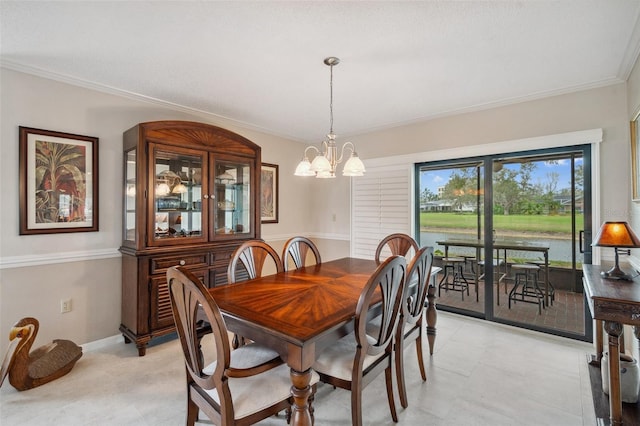 dining area with a chandelier, a water view, baseboards, and crown molding