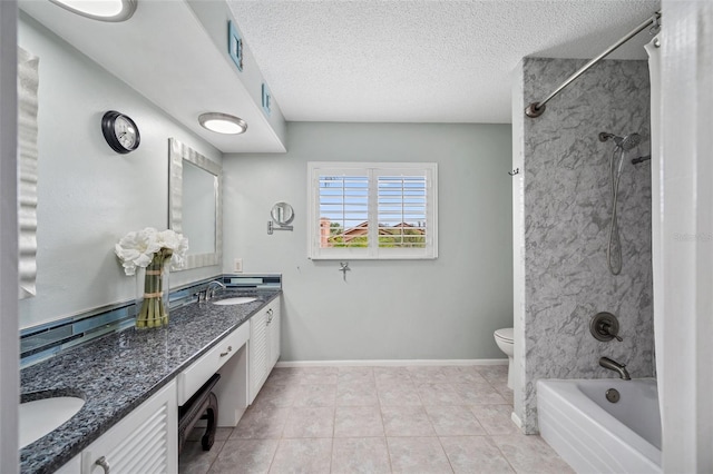 bathroom with tile patterned flooring, a sink, a textured ceiling, and double vanity