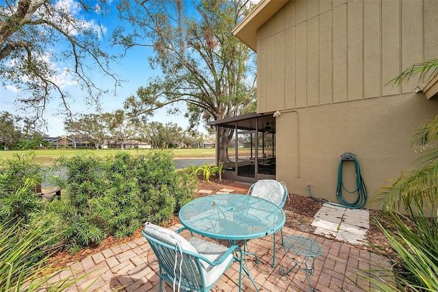 view of patio / terrace featuring a sunroom