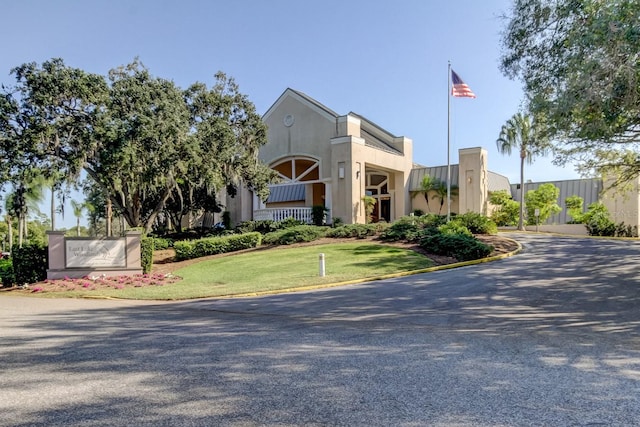 view of property featuring gravel driveway and fence