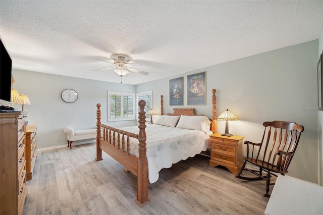 bedroom with light wood-style flooring, baseboards, ceiling fan, and a textured ceiling