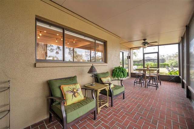 sunroom featuring a ceiling fan