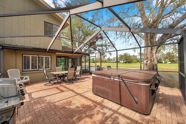 view of patio with outdoor dining area, a lanai, and a hot tub