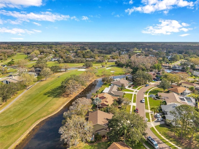 birds eye view of property featuring view of golf course, a water view, and a residential view