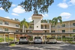 820 Virginia St Unit 207, Dunedin, FL 34698 - view of building exterior featuring covered parking