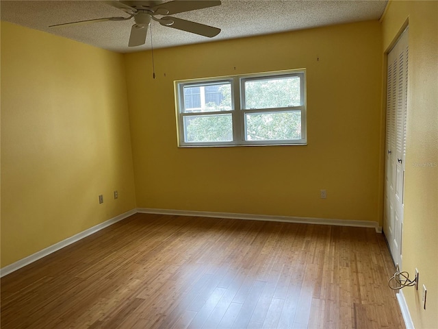 820 Virginia St Unit 207, Dunedin, FL 34698 - unfurnished room featuring ceiling fan, wood finished floors, and a textured ceiling