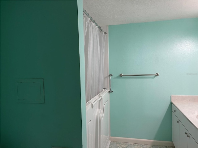 820 Virginia St Unit 207, Dunedin, FL 34698 - full bathroom featuring vanity, a textured ceiling, and a shower with shower curtain