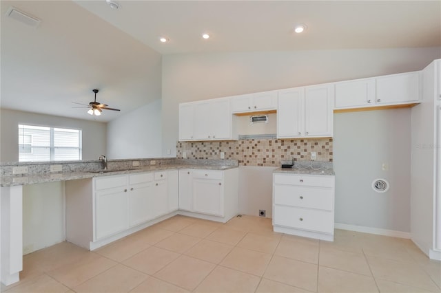 kitchen featuring white cabinetry, sink, light stone counters, ceiling fan, and lofted ceiling