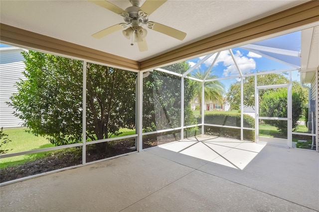 unfurnished sunroom with a healthy amount of sunlight and ceiling fan