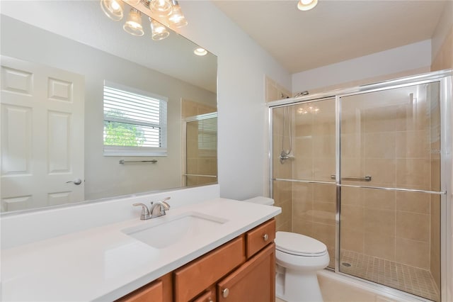 bathroom featuring toilet, vanity, and walk in shower