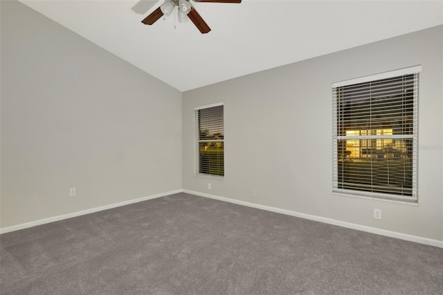 empty room featuring ceiling fan, carpet, and vaulted ceiling