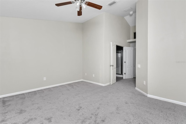 carpeted spare room featuring high vaulted ceiling and ceiling fan