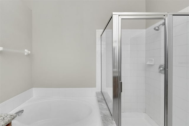 bathroom with separate shower and tub