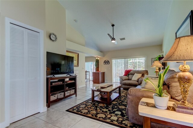 living room featuring light tile patterned flooring and high vaulted ceiling