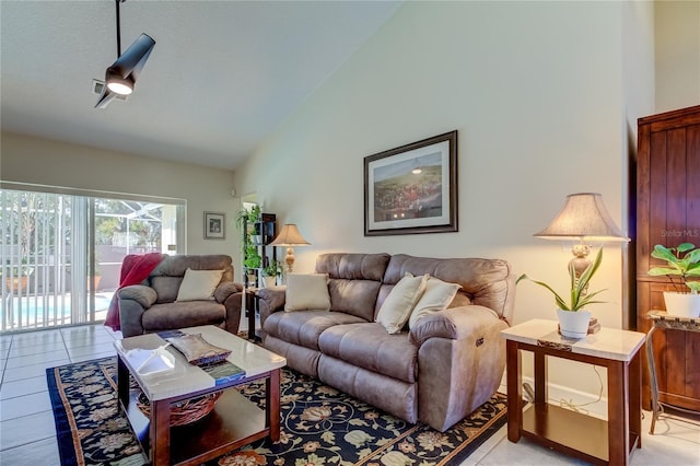 living room featuring light tile patterned floors and high vaulted ceiling