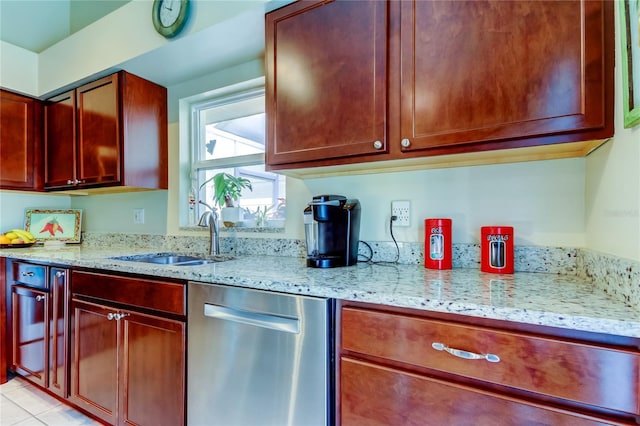 kitchen with light stone counters, sink, and dishwasher