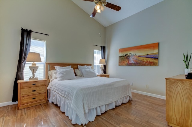 bedroom featuring light hardwood / wood-style flooring, high vaulted ceiling, and ceiling fan