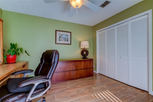 office featuring ceiling fan and light hardwood / wood-style flooring